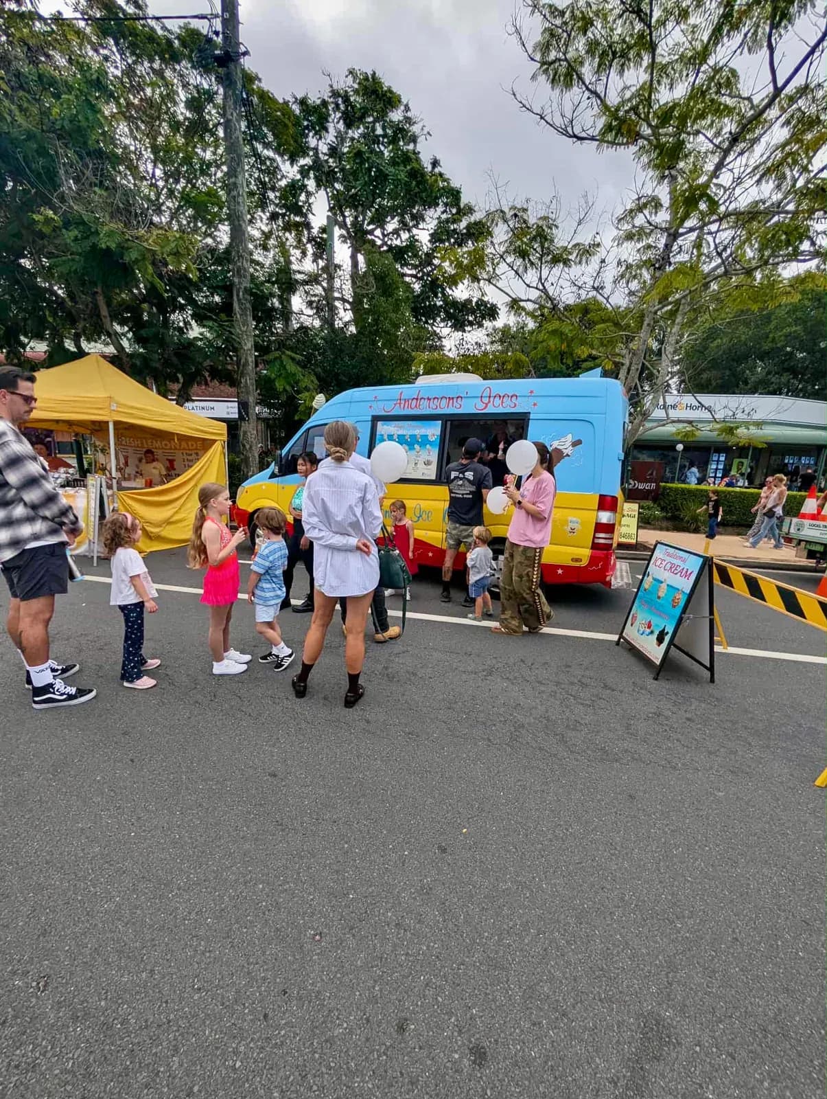 Families queuing at the Andersons' Ices ice cream van at the Mudgeeraba street party on the Gold Coast