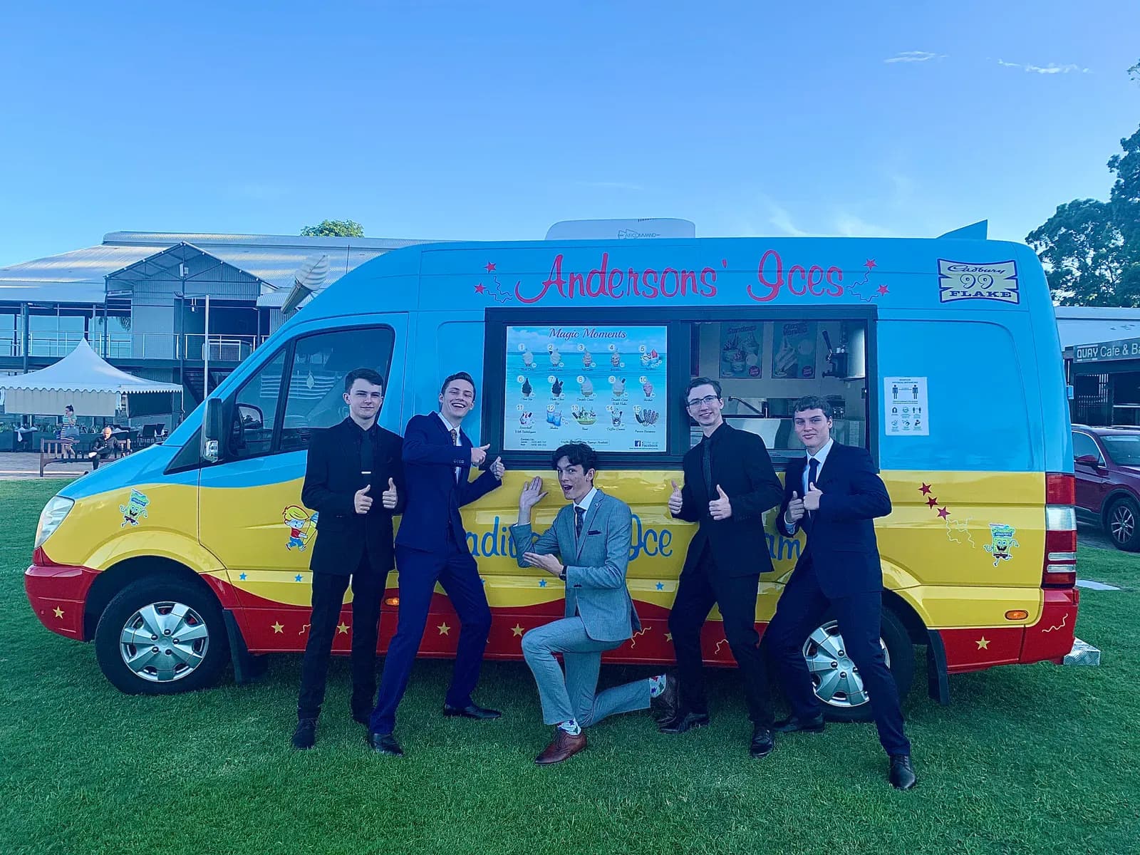 Five students in suits posing with the Andersons' Ices ice cream van hired for a Gold Coast school formal