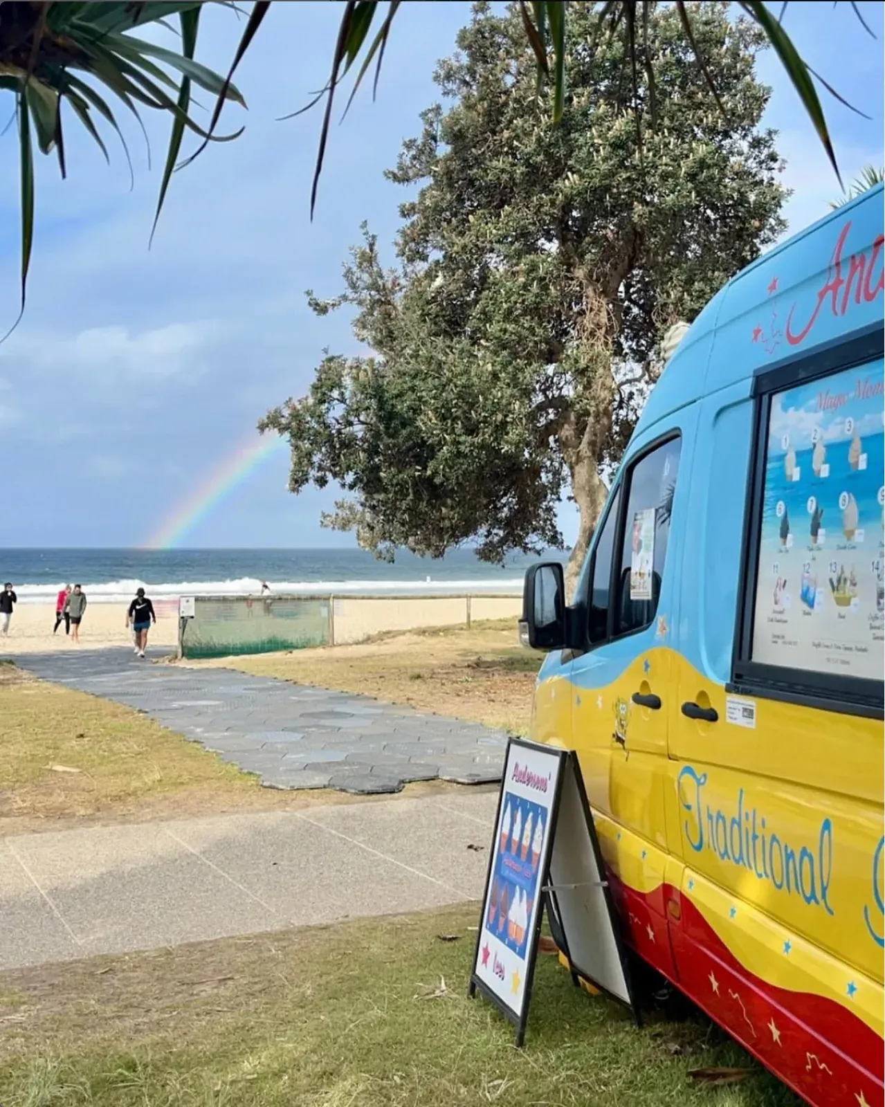 The Andersons' Ices ice cream truck parked by the beach under a rainbow on the Gold Coast